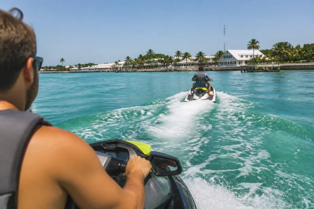 Jet ski riders following a guide along the Key West shoreline
