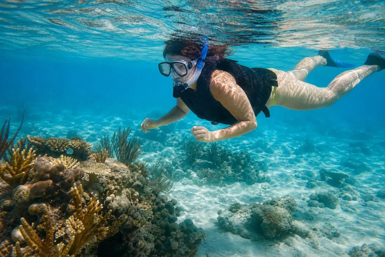 Beginner snorkeler floating above a shallow coral reef near Key West