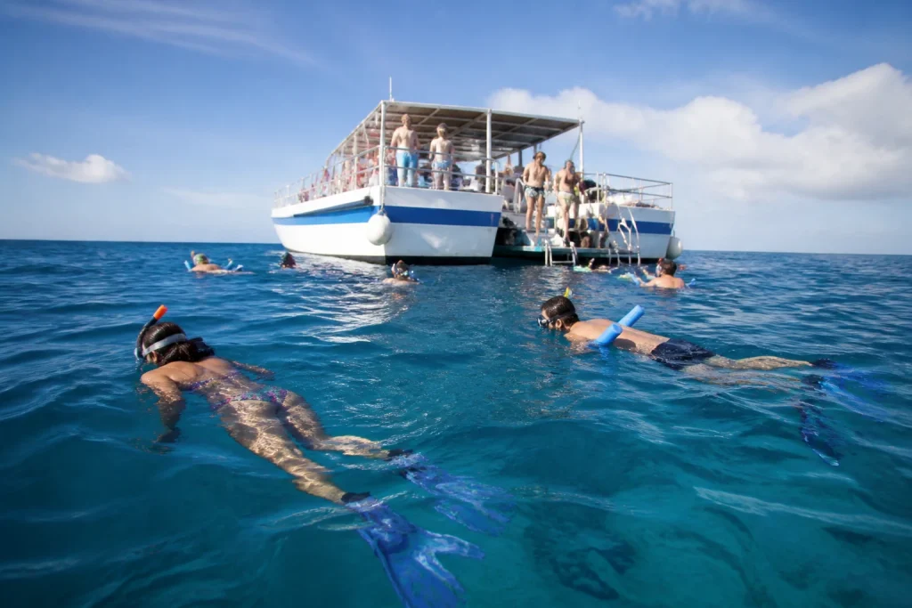 Snorkelers entering the water near a Key West tour boat