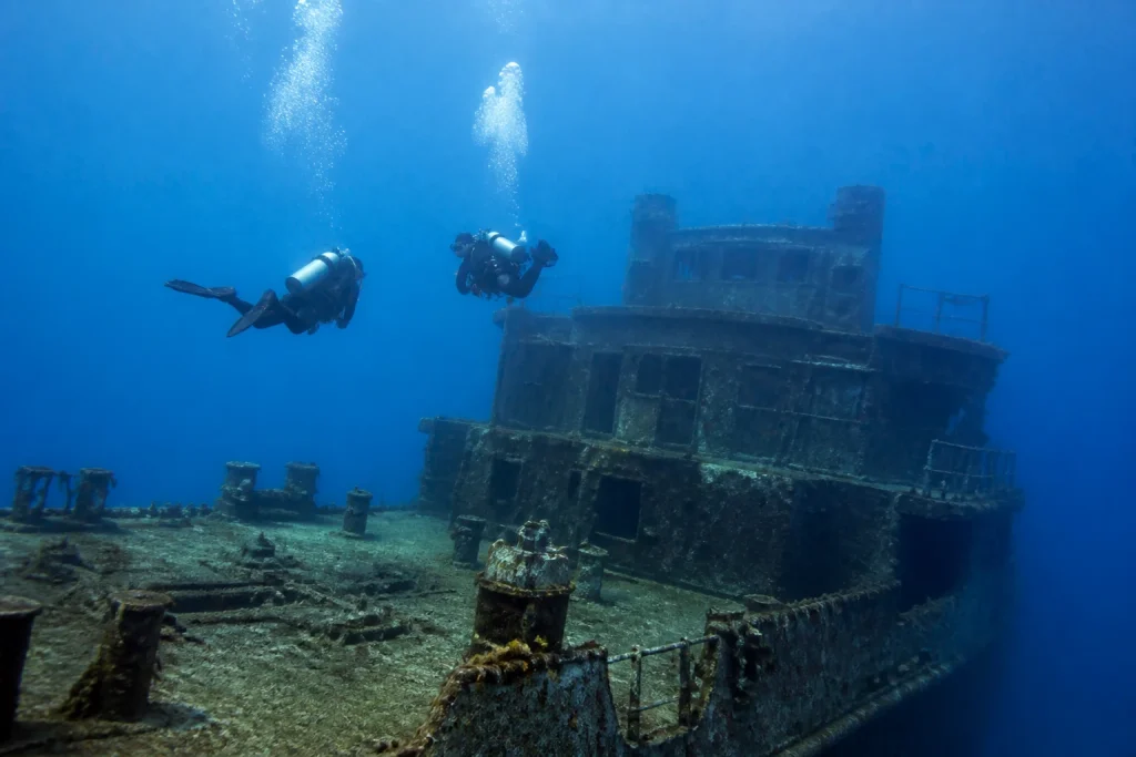 Advanced divers exploring the deck of a Key West shipwreck